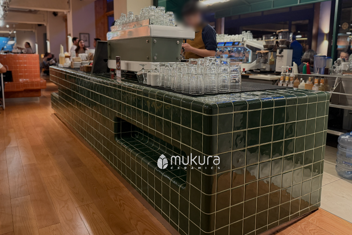 One of monolog coffee tables adorned with custom 3D handcrafted tiles, this one in dark green